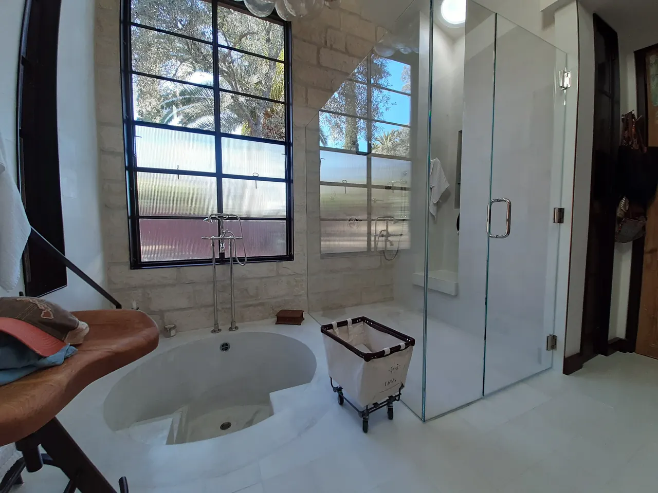 Finished bathroom with tub, shower, and plumbing fixtures